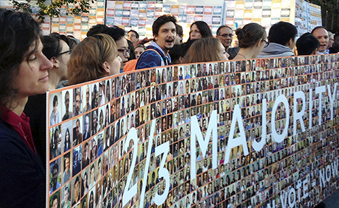 In this Oct. 15, 2015 photo, members of the Graduate Employee and Students Organization-Unite Here deliver a petition bearing the names and faces of hundreds of Yale University graduate student employees during a protest on campus in New Haven, Conn. (AP)