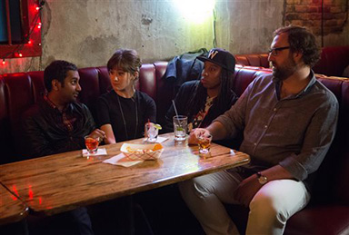 In this image released by Netflix, from left, Aziz Ansari, Noel Wells, Lena Waithe and Eric Wareheim appear in a scene from the Netflix original series “Master of None.” The comedy series premieres on Friday. (K.C. Bailey/Netflix via AP)