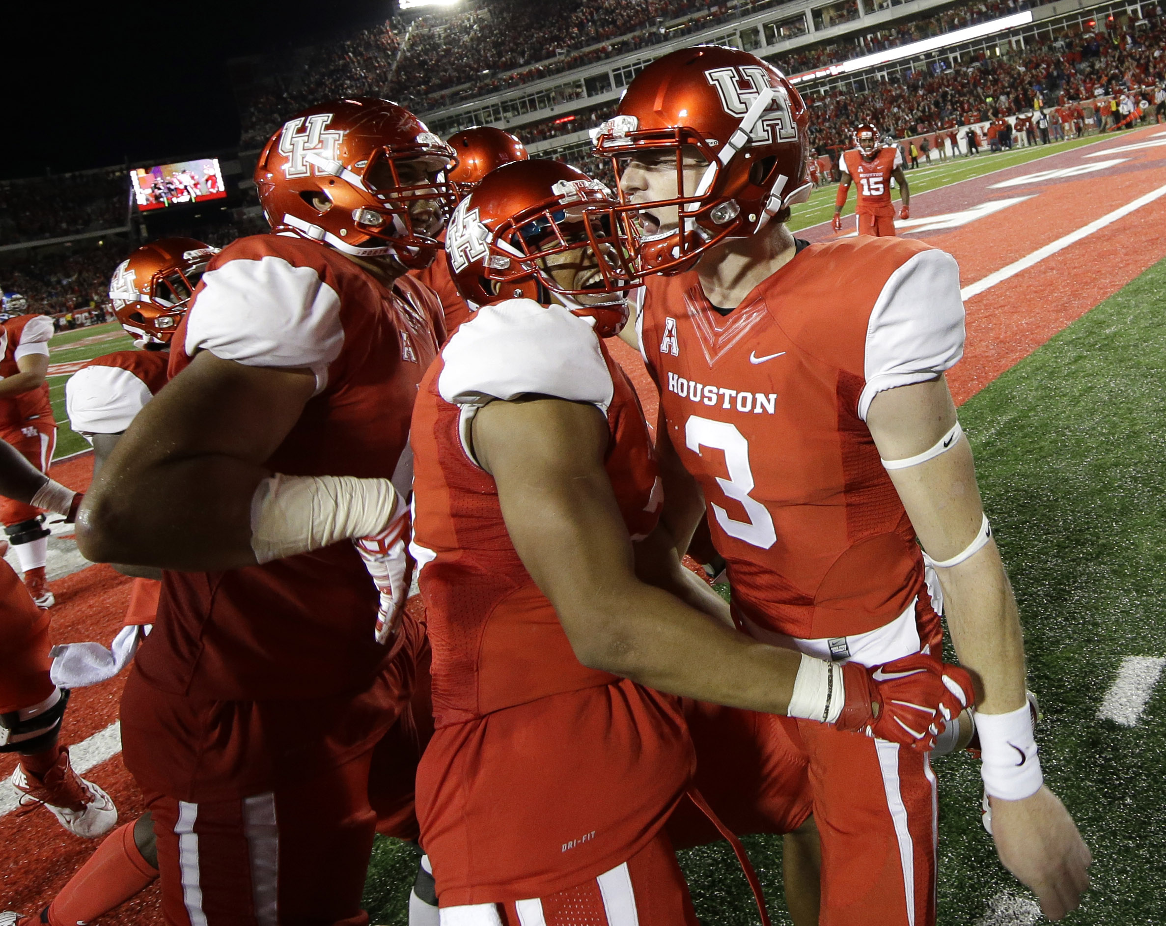 Houston quarterback Kyle Postma (3) celebrates with Chance Allen, center, and teammates after scoring a touchdown during the fourth quarter of an NCAA college football game against Memphis, Saturday, Nov. 14, 2015, in Houston. (David J. Phillip/AP)