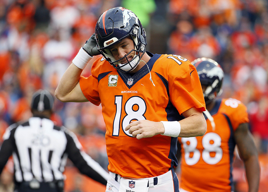 Denver Broncos quarterback Peyton Manning (18) takes off his helmet after throwing an interception during the first half of an NFL football game against the Kansas City Chiefs, Sunday, Nov. 15, 2015, in Denver. (AP
