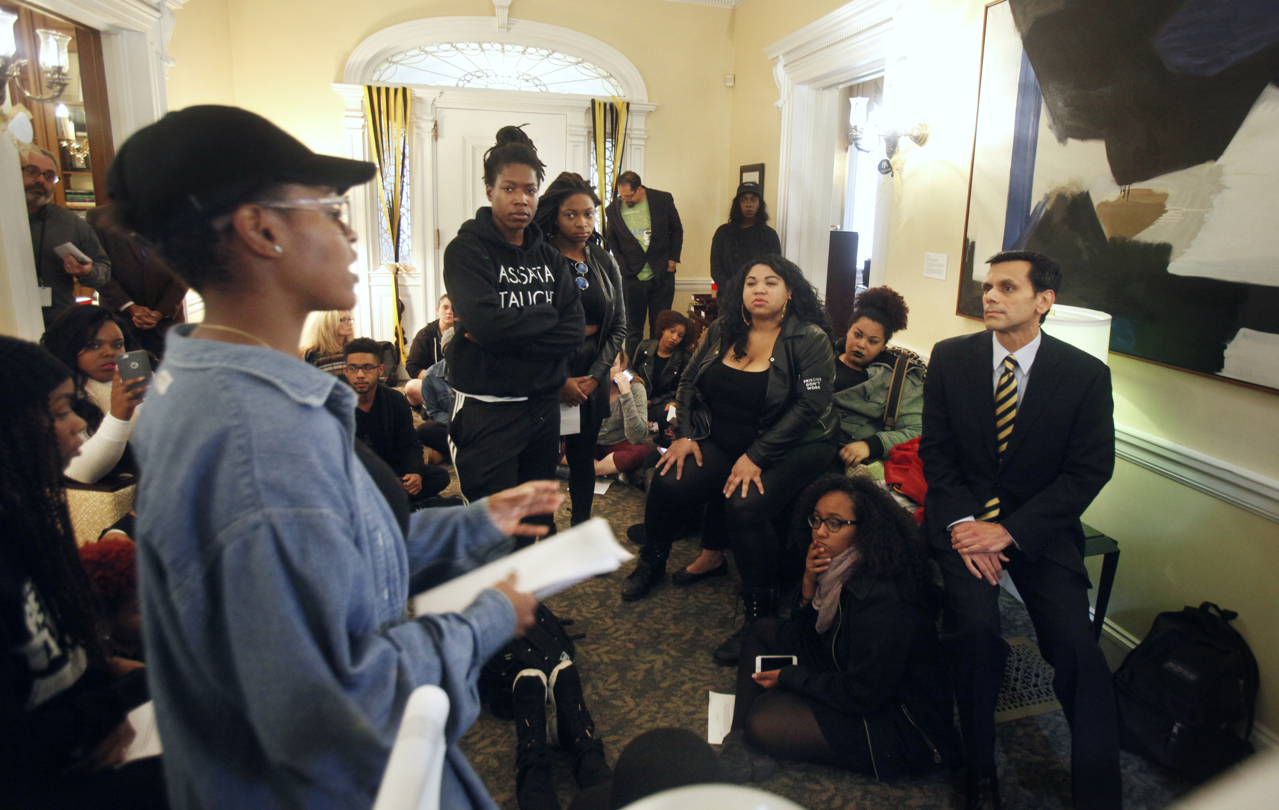 Virginia Commonwealth University President Michael Rao, right, listens to complaints from a group of students inside the entrance of the president's office, Thursday Nov. 12, 2015, in Richmond, Va. Thousands of students across the U.S. took part in demonstrations at university campuses Thursday to show solidarity with protesters at the University of Missouri, and to shine a light on what they say are racial problems at their own schools. (AP)