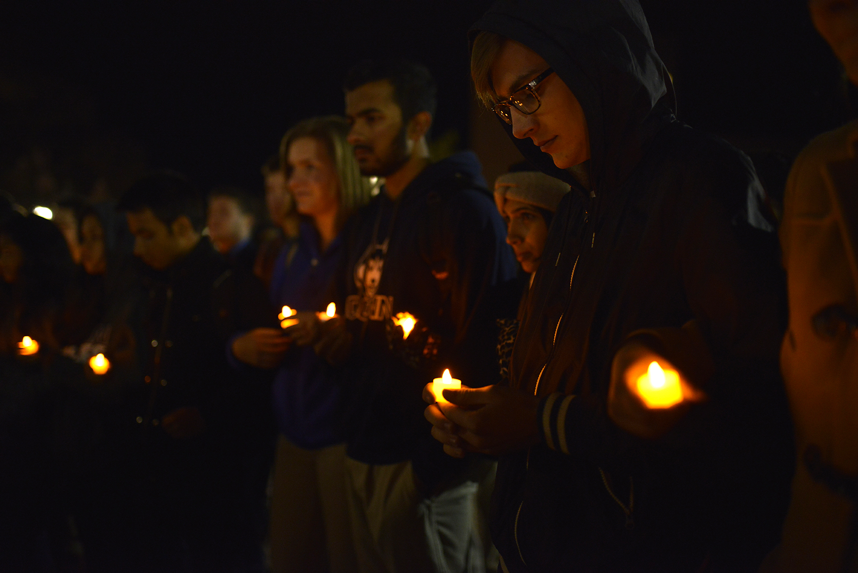 Students hold candles as part of a vigil on Fairfield Way Wed., Nov. 18 to honor victims of Islamophobia. The vigil was held by Asian American Cultural Center (AsAAC) as part of a series named “Salaam.” (Jason Jiang/Daily Campus)