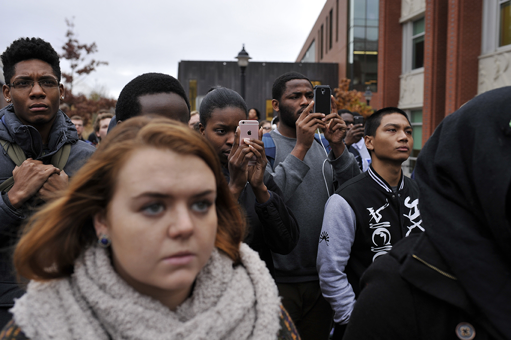 Students are seen watching the demonstration and recording on their phones on Fairfield Way in Storrs, Connecticut on Thursday, Nov. 19, 2015. (Jason Jiang/The Daily Campus)