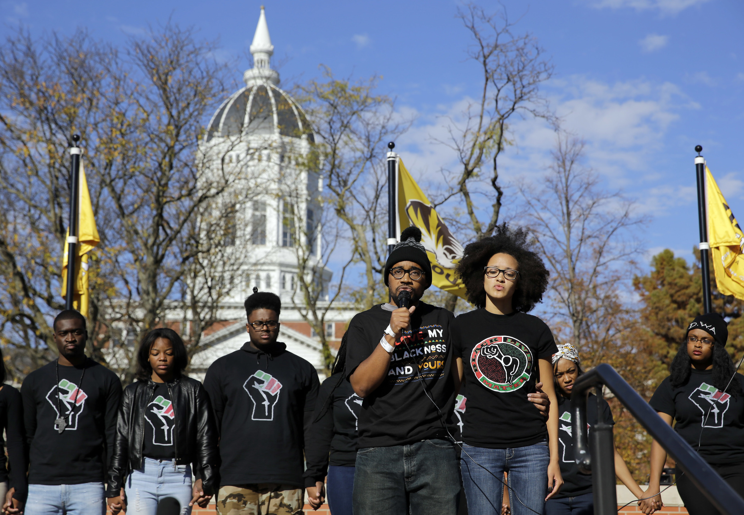 In this Nov. 9, 2015, file photo, Jonathan Butler, center, addresses a crowd following the announcement that University of Missouri System President Tim Wolfe would resign, in Columbia, Mo. (Jeff Roberson, File/AP)