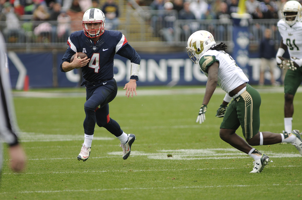 UConn quarterback Bryant Shirreffs running with the ball against South Florida in UConn's homecoming game. He finished the game with over 100 rushing yards. (Bailey Wright/The Daily Campus)
