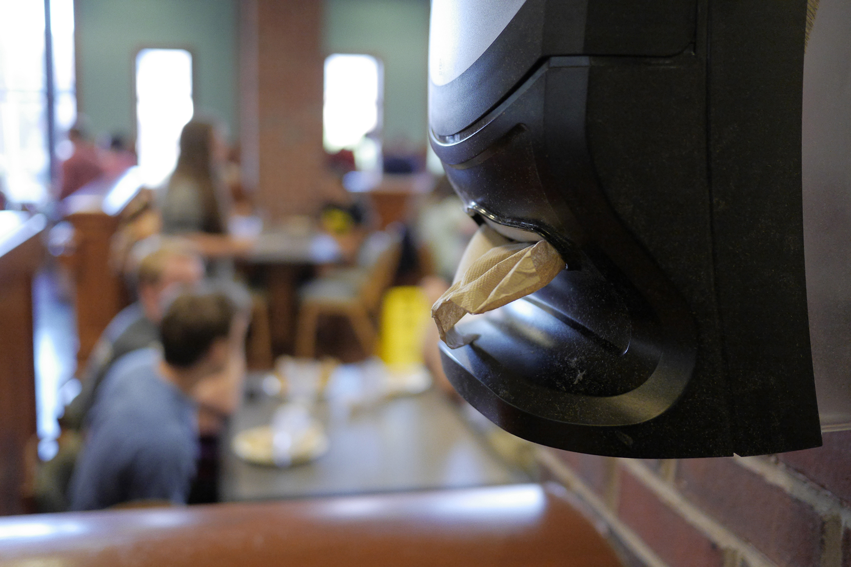 In this file photo, a wall-mounted napkin dispenser is seen in South Dining Hall. Dining Services recently shifted over to more widespread use of wall-mounted dispensers instead of having a dispenser on each table. (File Photo/The Daily Campus)