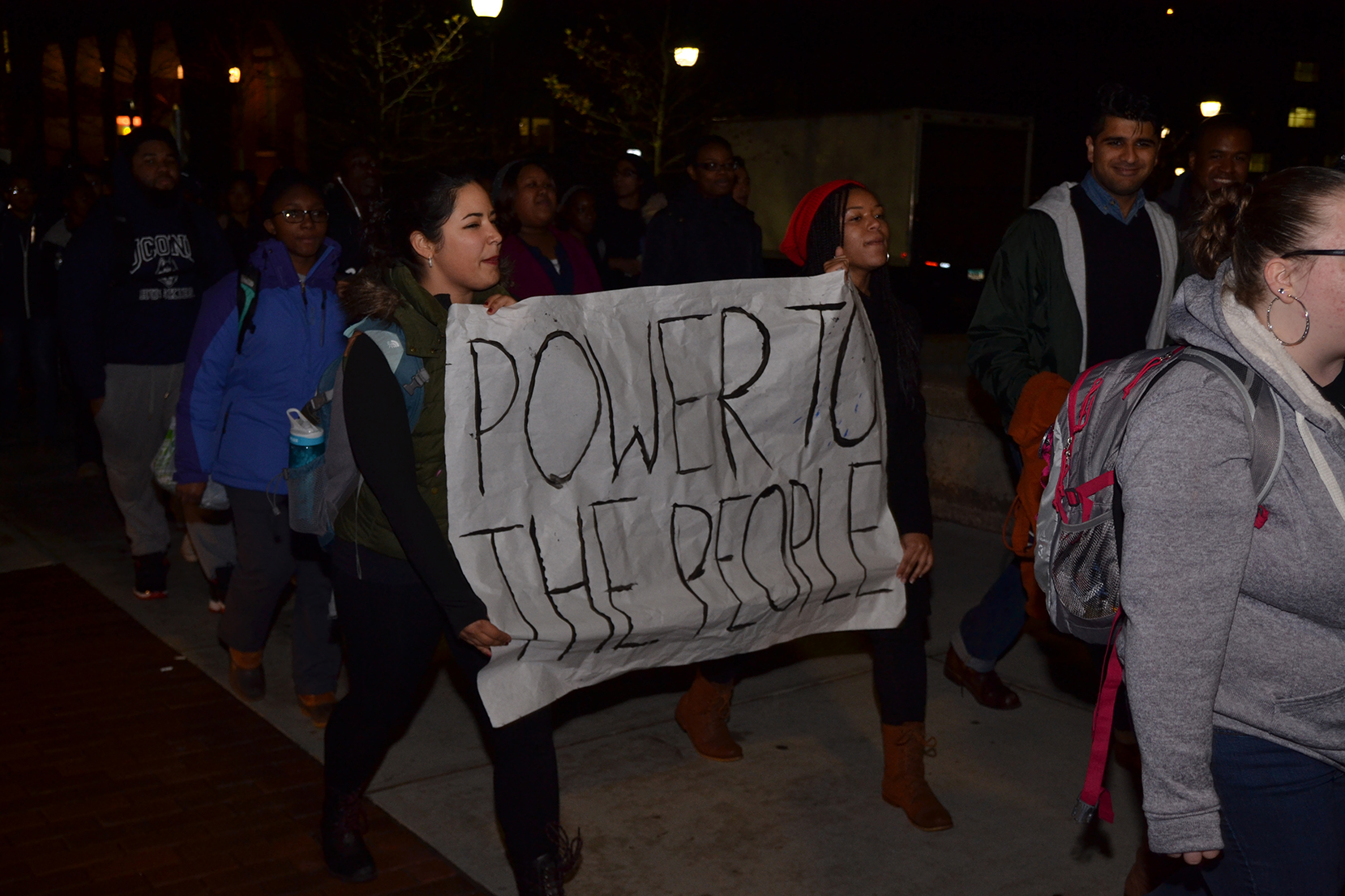 Students walk during the "March for Justice, Empowerment and Solidarity," holding a sign that reads "Power To The People" on Fairfield Way in Storrs, Connecticut on Thursday, Nov. 19, 2015. (Amar Batra/The Daily Campus)