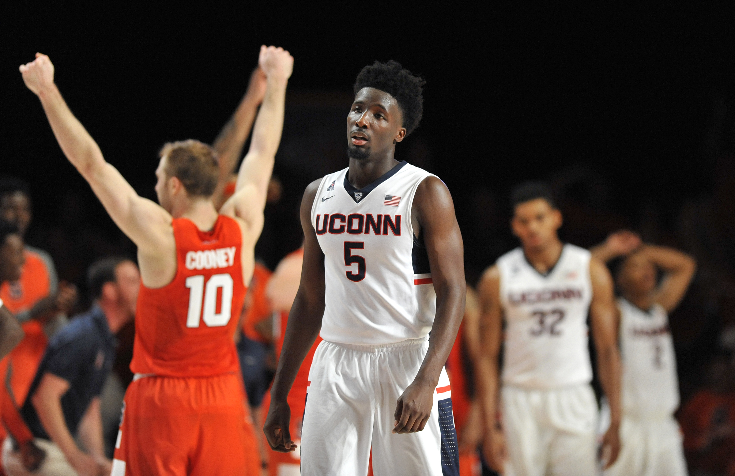Connecticut forward Daniel Hamilton (5) and teammates walk off after losing to Syracuse during an NCAA college basketball game in the semifinals of the Battle 4 Atlantis, Thursday, Nov. 26, 2015. At left is Syracuse's Trevor Cooney. Syracuse defeated Connecticut 79-76. (Brad Horrigan/The Courant via AP)