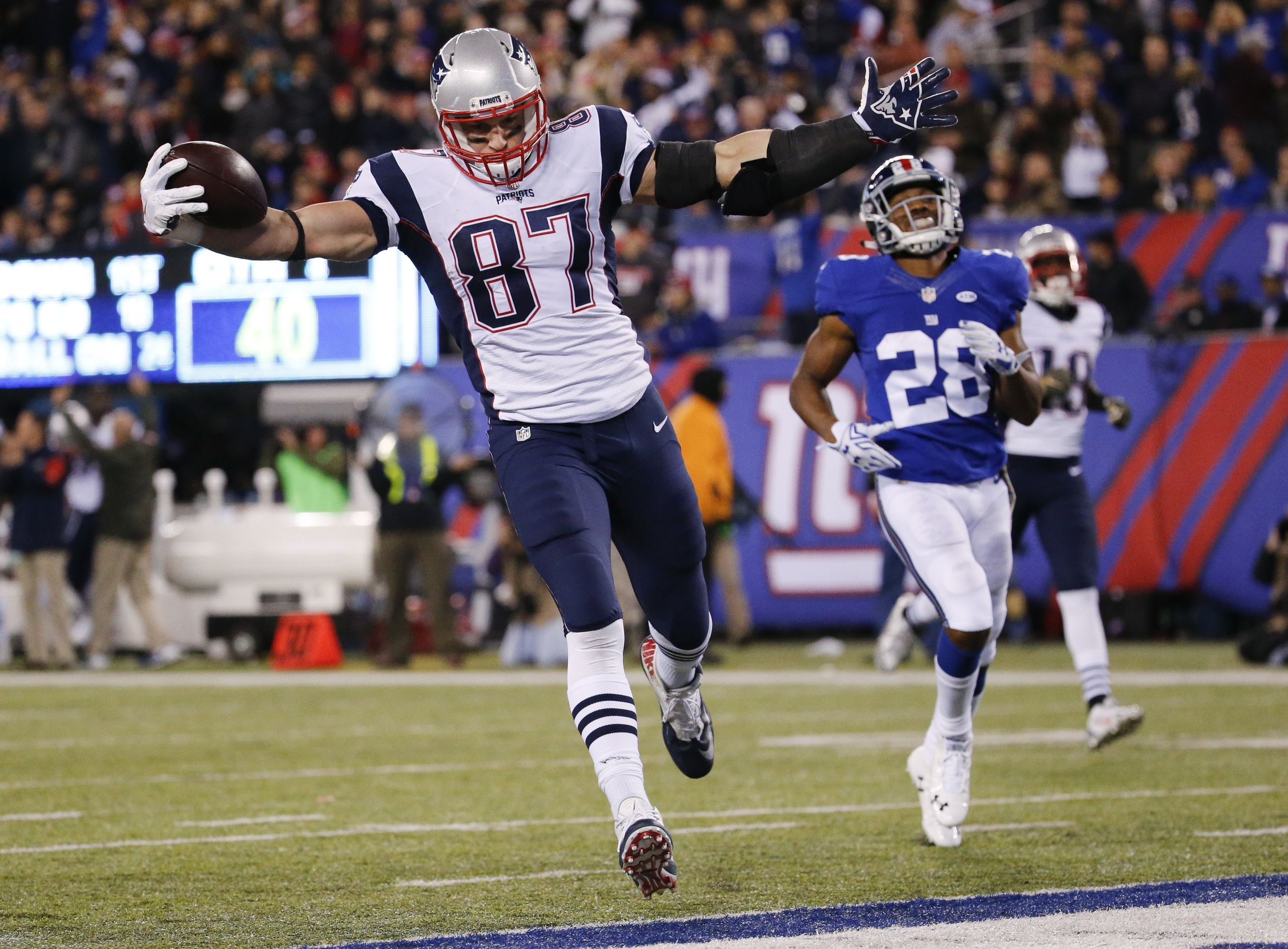 In this Nov. 15, 2015, file photo, New England Patriots' Rob Gronkowski (87) scores a touchdown in front of New York Giants' Jayron Hosley (28) during the second half of an NFL football game in East Rutherford, N.J. (Julio Cortez/AP)