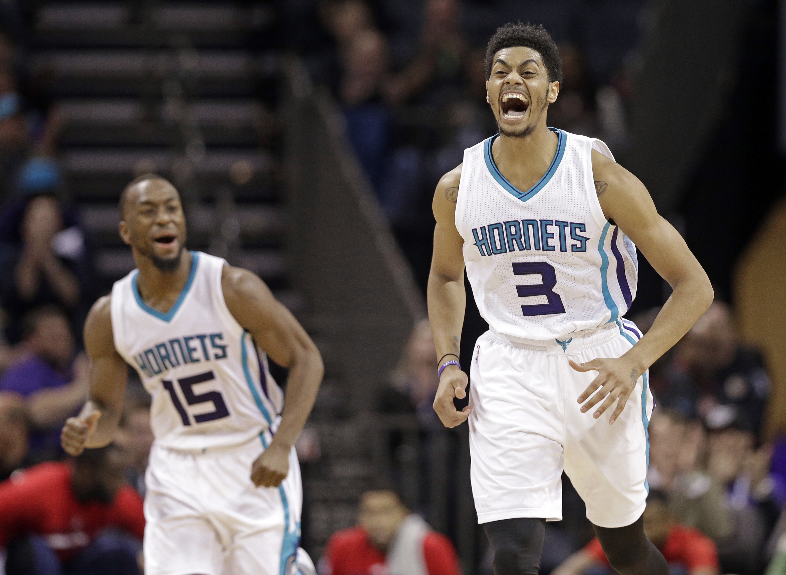 Charlotte Hornets' Jeremy Lamb (3) and Kemba Walker (15) react after Lamb's basket against the Washington Wizards in the second half of an NBA basketball game in Charlotte, N.C., Wednesday, Nov. 25, 2015. The Hornets won 101-87. (Chuck Burton/AP)