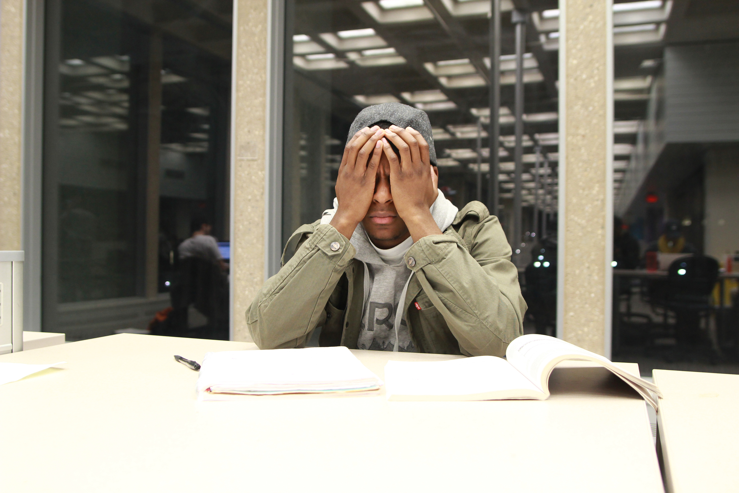 In this file photo, a stressed student in the library studies in Homer Babbidge library. A recent study by the student activities department shows that academics are one of the top two stresses in student leaders. (File photo/The Daily Campus)