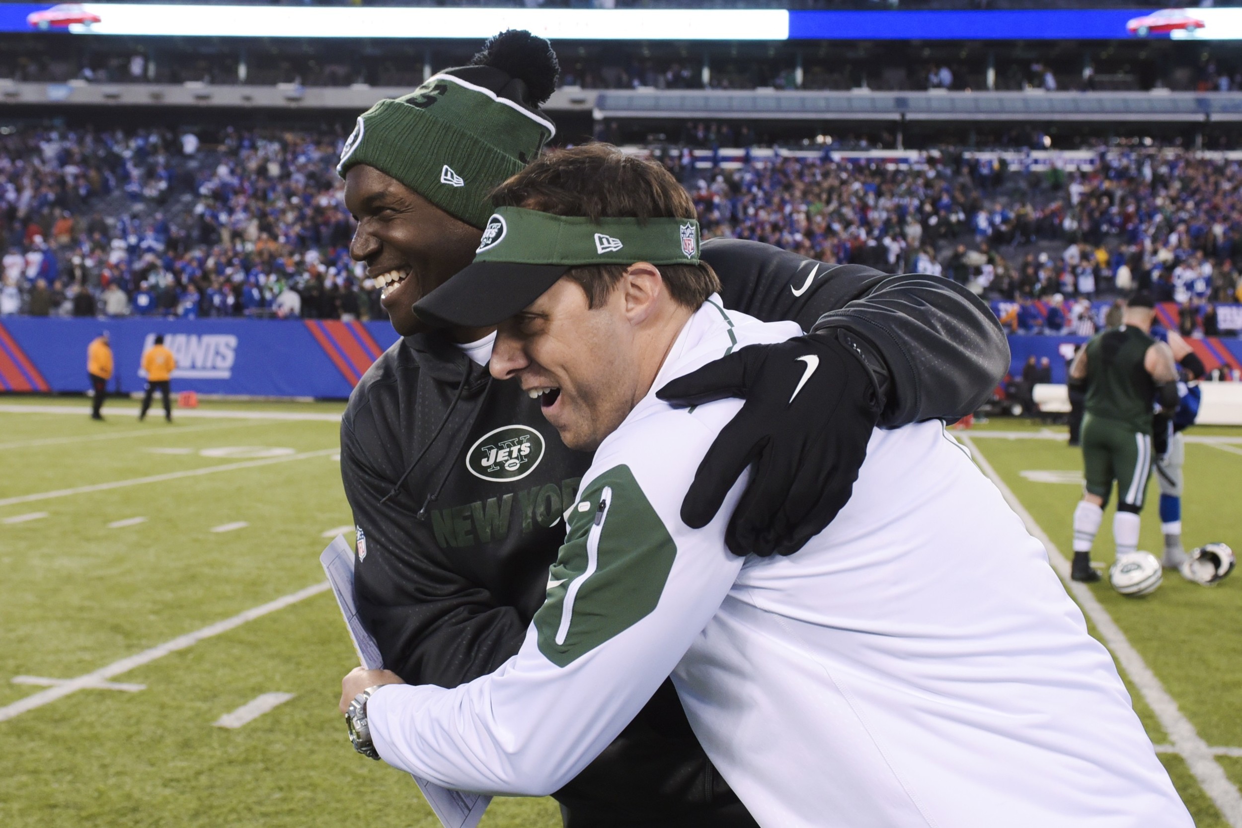 New York Jets head coach Todd Bowles, left, hugs quarterbacks coach Kevin Patullo, right, after an NFL football game against the New York Giants Sunday, Dec. 6, 2015, in East Rutherford, N.J. The Jets won 23-20. (AP Photo/Bill Kostroun)