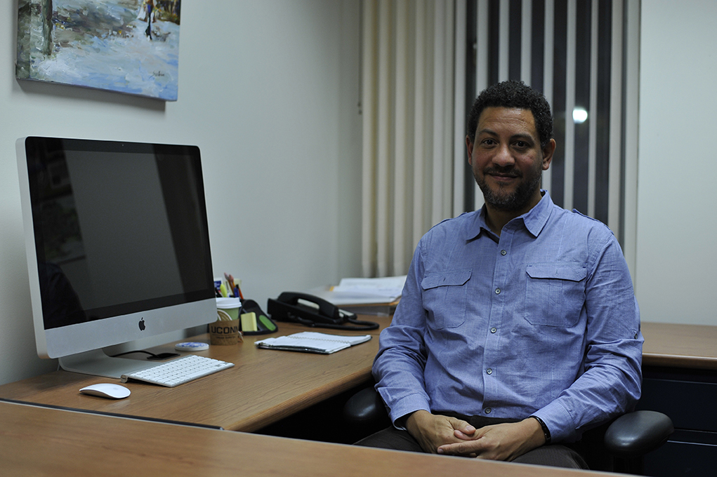 Psychology professor Colin Leach is seen sitting in his office. Leach has been studying how shame can positively affect some students while negatively affecting others. (Jason Jiang/The Daily Campus)