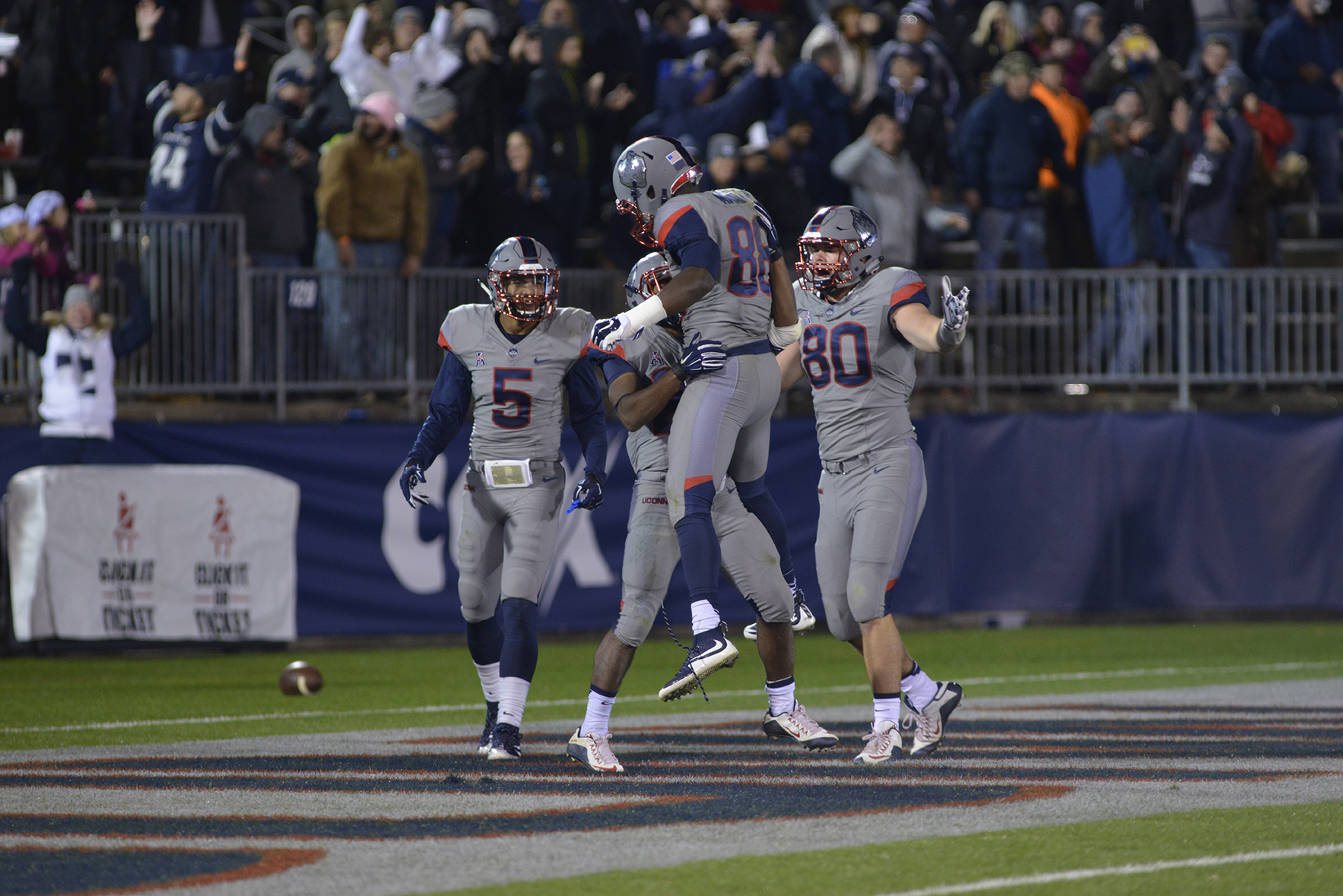 UConn players celebrate after a touchdown from running back Arkeel Newsome (second from left) during the Huskies' game against East Carolina at Pratt & Whitney Stadium at Rentschler Field in East Hartford, Connecticut on Friday, Oct. 30, 2015. (Jason Jiang/The Daily Campus)