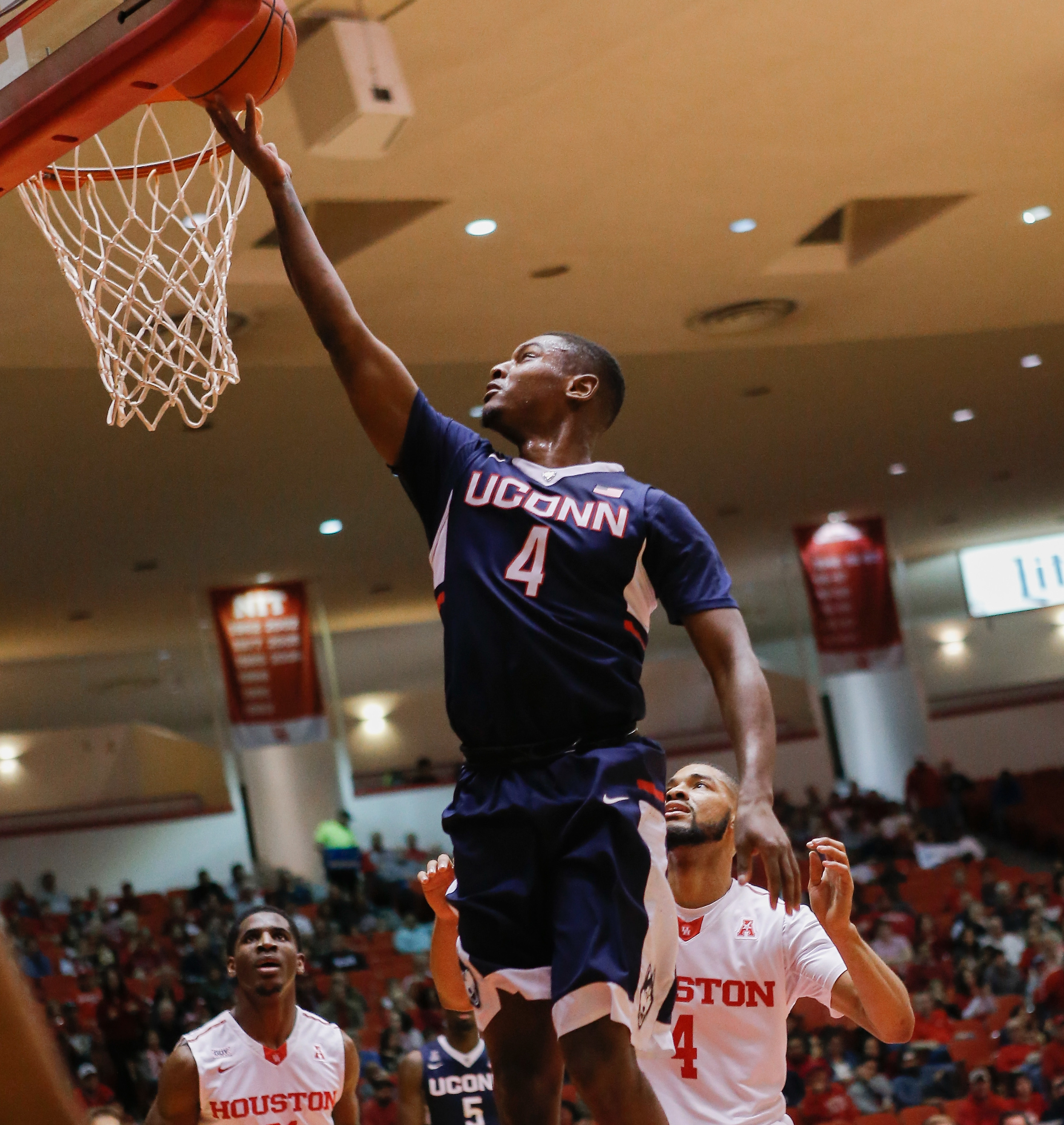 Connecticut guard Sterling Gibbs (4) drives to the basket for a layup past Houston guard LeRon Barnes (4) during the first half of an NCAA college basketball game Sunday, Jan. 17, 2016, in Houston. (AP Photo/Bob Levey)