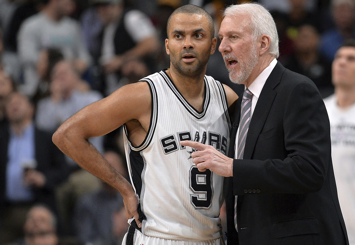San Antonio Spurs coach Gregg Popovich, right, talks to guard Tony Parker, of France, during the second half of an NBA basketball game against the Cleveland Cavaliers, Thursday, Jan. 14, 2016, in San Antonio. San Antonio won 99-95. (AP Photo/Darren Abate)