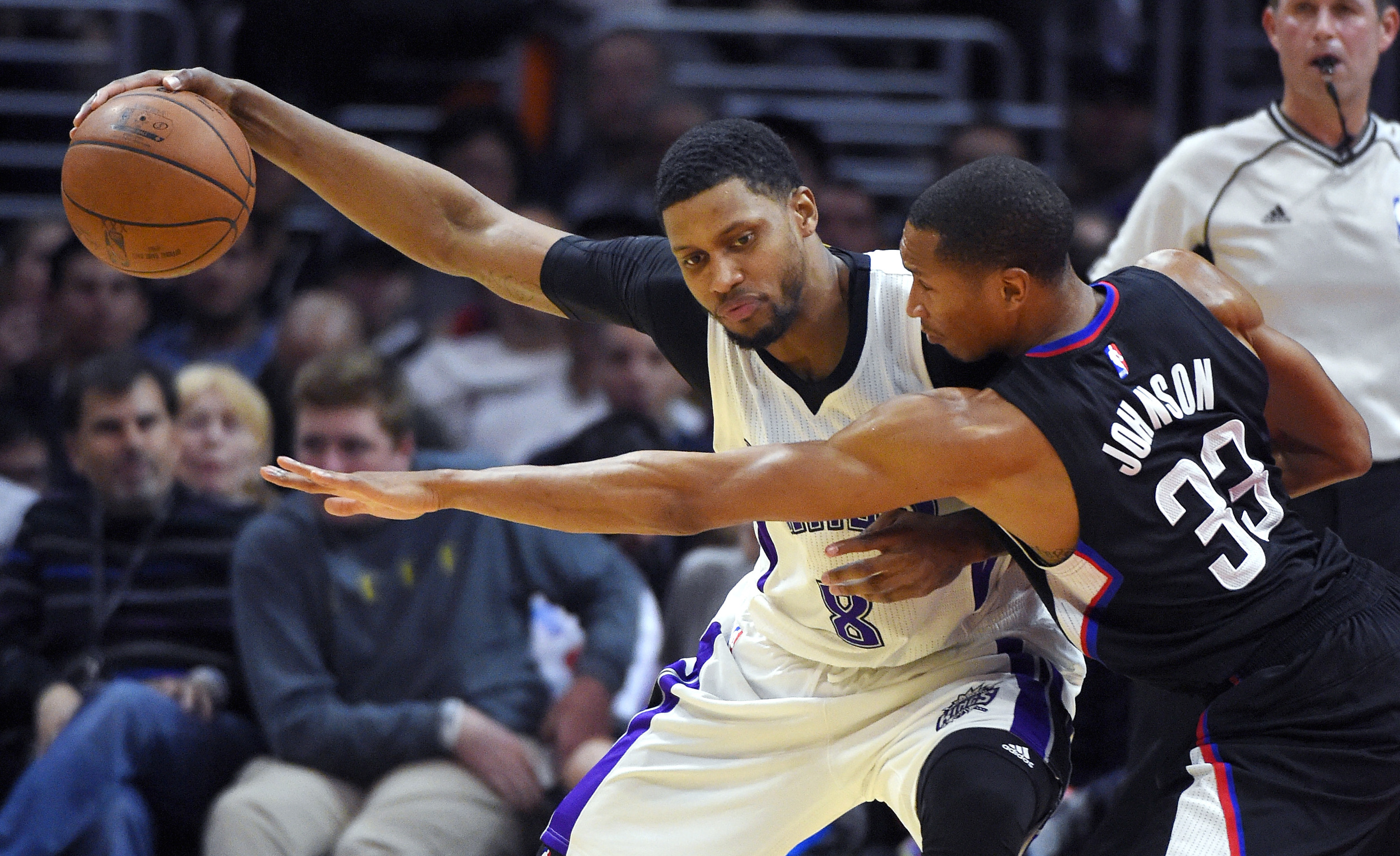Los Angeles Clippers forward Wesley Johnson, right, reaches for the ball held by Sacramento Kings forward Rudy Gay during the first half of an NBA basketball game, Saturday, Jan. 16, 2016, in Los Angeles. (Mark J. Terrill/AP)