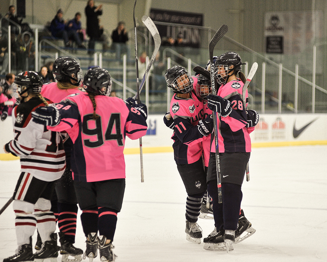 Members of the UConn women's ice hockey team celebrate after a goal during the team's game against No. 6 Northeastern at Freitas Ice Forum on Jan. 23, 2016. (Jason Jiang/The Daily Campus)