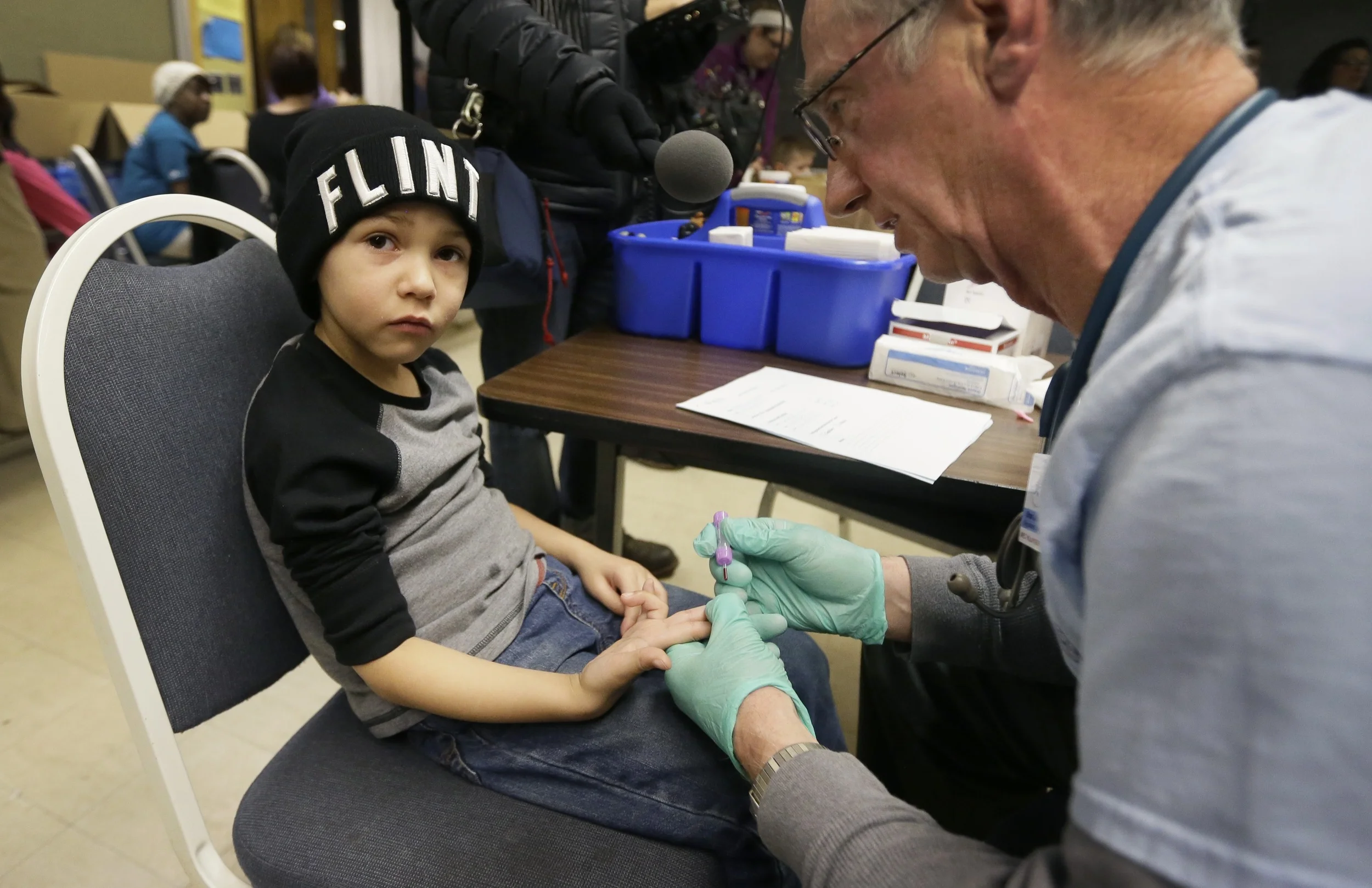 Registered Nurse Brian Jones draws a blood sample from Grayling Stefek, 5, at the Eisenhower Elementary School, Tuesday, Jan. 26, 2016 in Flint, Mich. The students were being tested for lead after the metal was found in the city's drinking water. (AP)