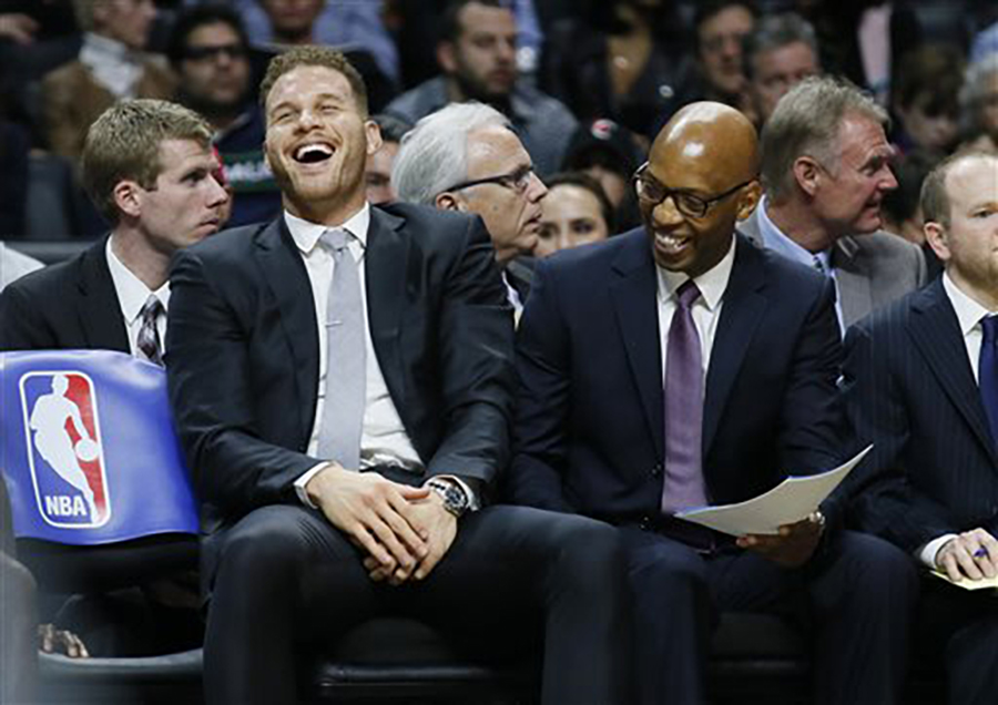 What's Blake Griffin laughing about? Probably not his recent fight with a trainer. Los Angeles Clippers' Blake Griffin , left, laughs on the bench with assistant coach Sam Cassell, right, during the second half of an NBA basketball game Wednesday, Jan. 13, 2016, in Los Angeles. The Clippers won 104-90. (AP Photo/Danny Moloshok)
