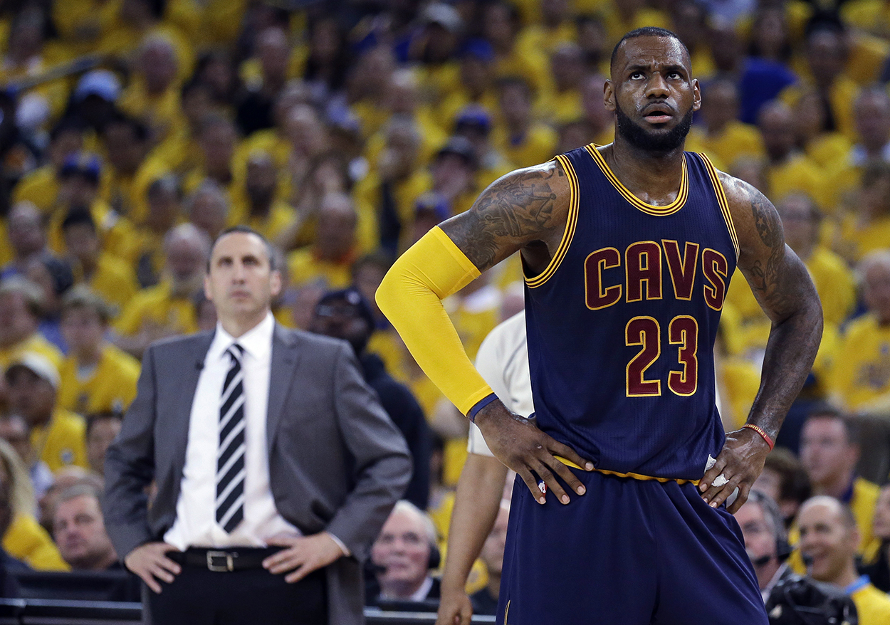 n this June 7, 2015, file photo, Cleveland Cavaliers forward LeBron James stands on the court near coach David Blatt during Game 2 of basketball's NBA Finals against the Golden State Warriors in Oakland, Calif. James ’ calculating image wasn’t helped when the Cavaliers stunningly fired Blatt on Friday, Jan. 22. (AP Photo/Ben Margot, File)