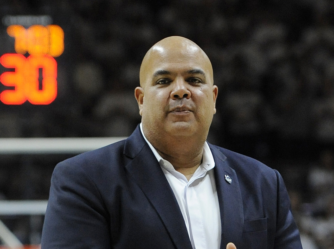 FILE - In this Dec. 5, 2015, file photo, UConn Athletic Director Warde Manuel is shown during a basketball game betweemn UConn and Notre Dame in Storrs, Conn. Two high ranking UConn officials say the school's athletic director has been offered the same job at Michigan. The officials spoke to The Associated Press on condition of anonymity Wednesday, Jan. 27, 2016, because Michigan has made no official announcements about the opening. (AP Photo/Jessica Hill, File)