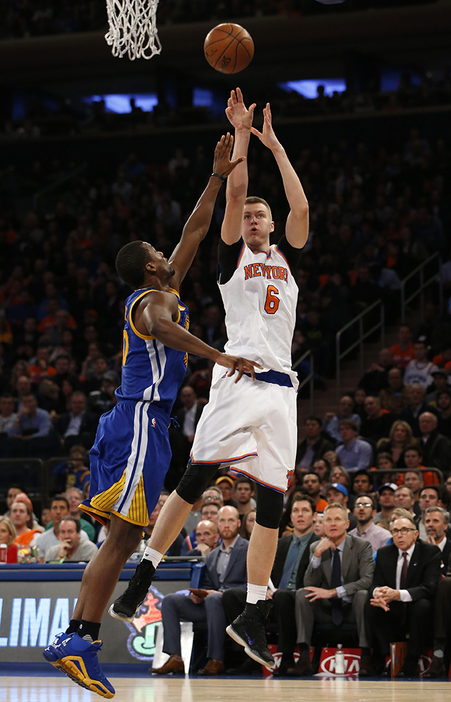 New York Knicks forward Kristaps Porzingis (6) shoots over Golden State Warriors forward Harrison Barnes. The Warriors defeated the Knicks 116-95. (AP Photo/Kathy Willens)