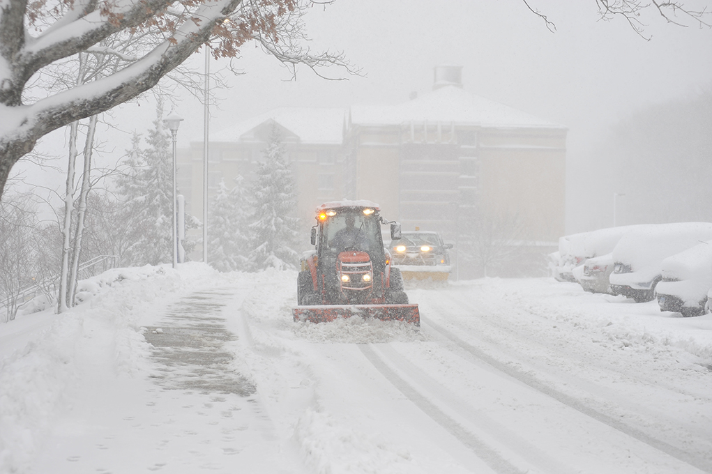 A tractor and snow plow are seen plowing near the Nathan Hale Inn and South campus during a snow storm on Friday, Feb. 5, 2016. The storm resulted in classes being cancelled for the day. (Jason Jiang/The Daily Campus)
