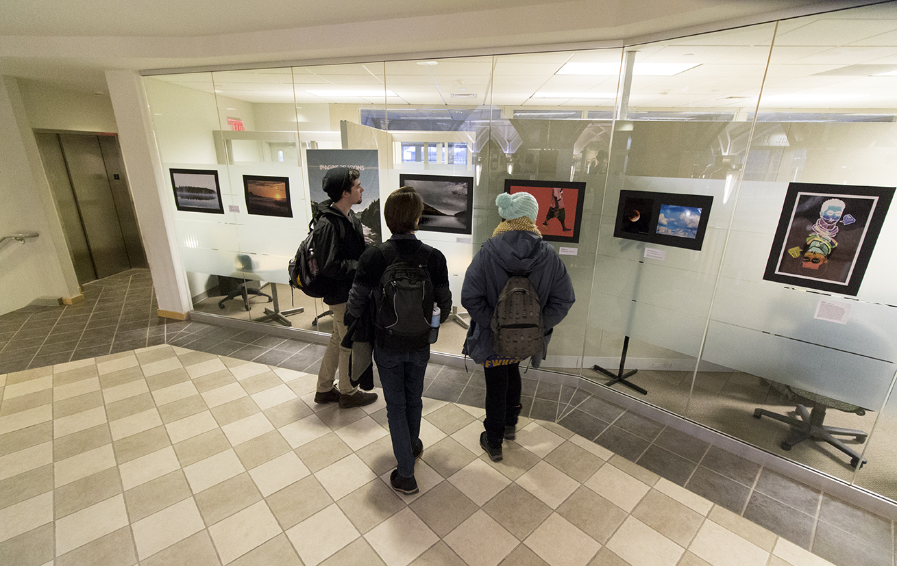 Students view artwork during a student art exhibition hosted by the Center for Career Development on the second floor of the Wilbur Cross Building on Wednesday, Feb. 10, 2016. (Jackson Mitchell/The Daily Campus)