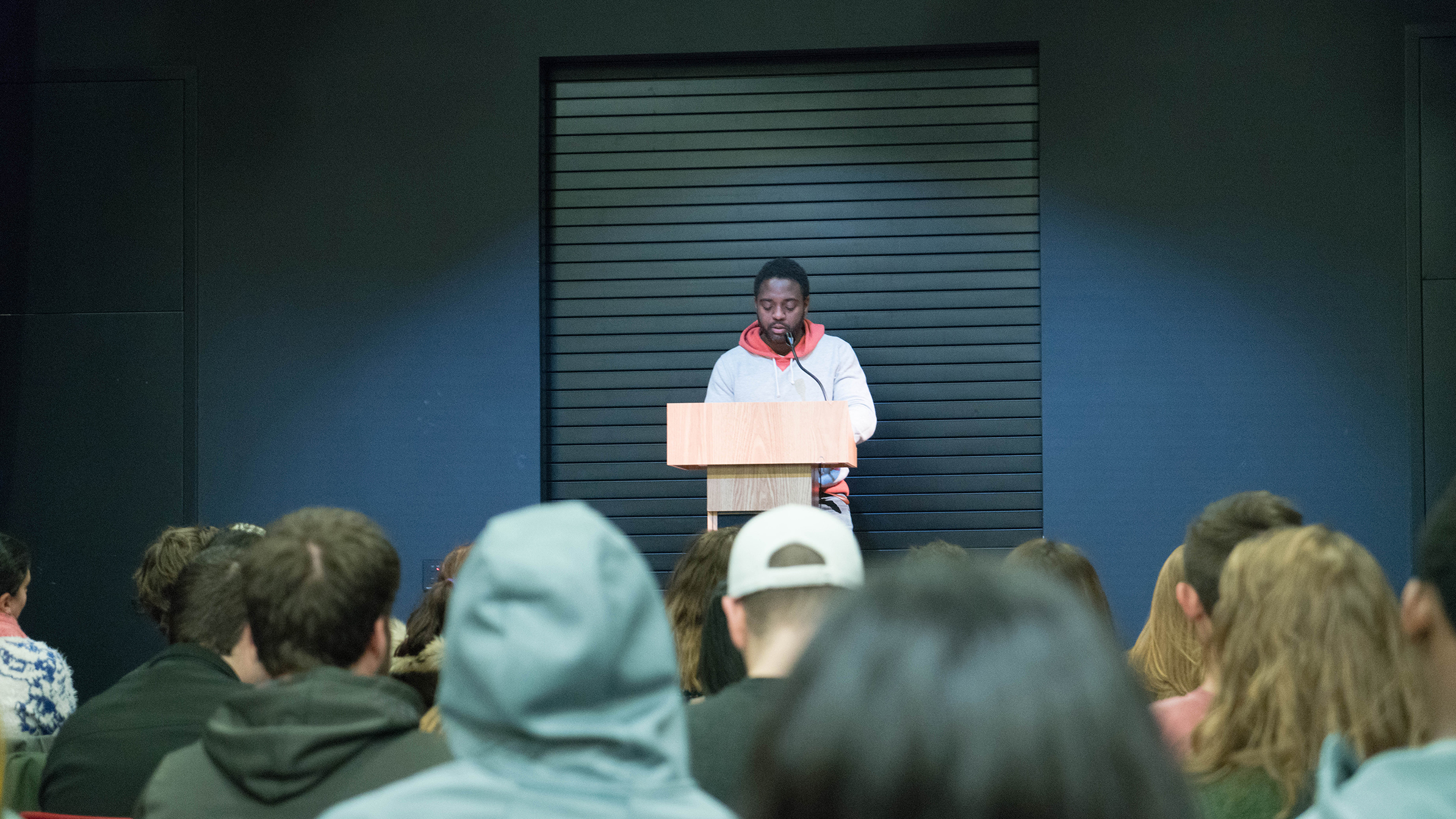 Reginald Swayne Betts, memoirist and teacher, gives a poetry reading at the Storrs Center Co-op Bookstore (Erming Gao/The Daily Campus)
