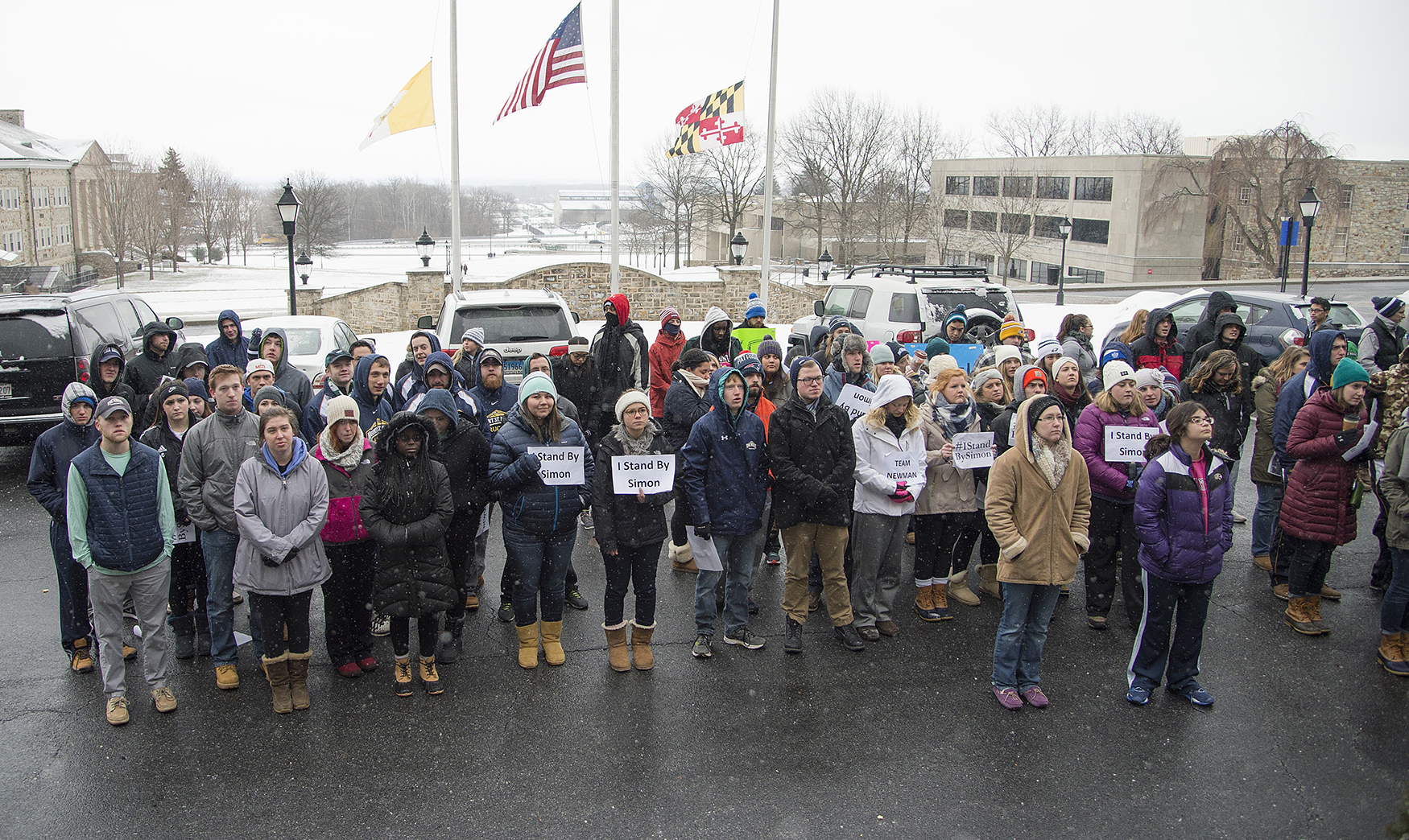 Students, some with signs, gather at a rally in support of Mount St. Mary's University President Simon Newman on Monday, Feb. 15, 2016, in Emmitsburg, Md. Newman rejected the faculty's demand for his resignation Monday after a majority of students expressed support for his leadership, including a bluntly pragmatic plan to boost the academic ranking of the nation's second-oldest Catholic university. (Bill Green/The Frederick News-Post via AP) MANDATORY CREDIT