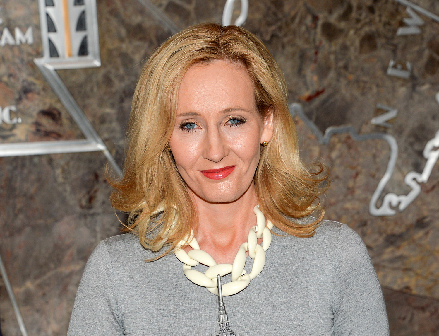 In this April 9, 2015 file photo, "Harry Potter" author J.K. Rowling lights the Empire State Building to mark the launch of her non-profit children's organization Lumos, in New York. Scholastic Inc. announced Wednesday, Feb. 10, 2016, that a “script book” of “Harry Potter and the Cursed Child” will be published July 31. The book is a based on the two-part stage collaboration of Rowling, Jack Thorne and John Tiffany and arrives just after the play premieres in London July 30. (Photo by Evan Agostini/Invision/AP, File)
