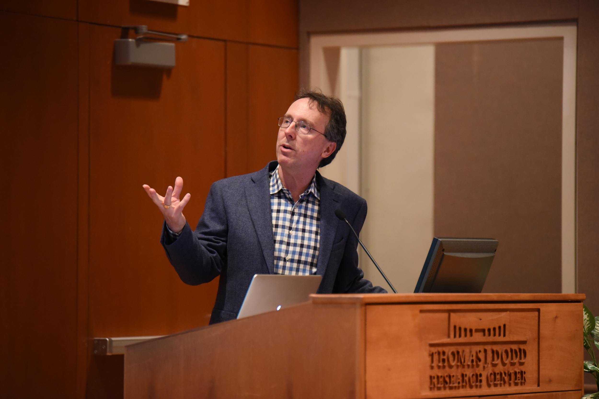 Sports Illustrated writer Alexander Wolff gives a lecture on his book "The Audacity of Hoop" in the Konover Auditorium at the Dodd Center on Monday, March 22. (Zhelan Lang/The Daily Campus)