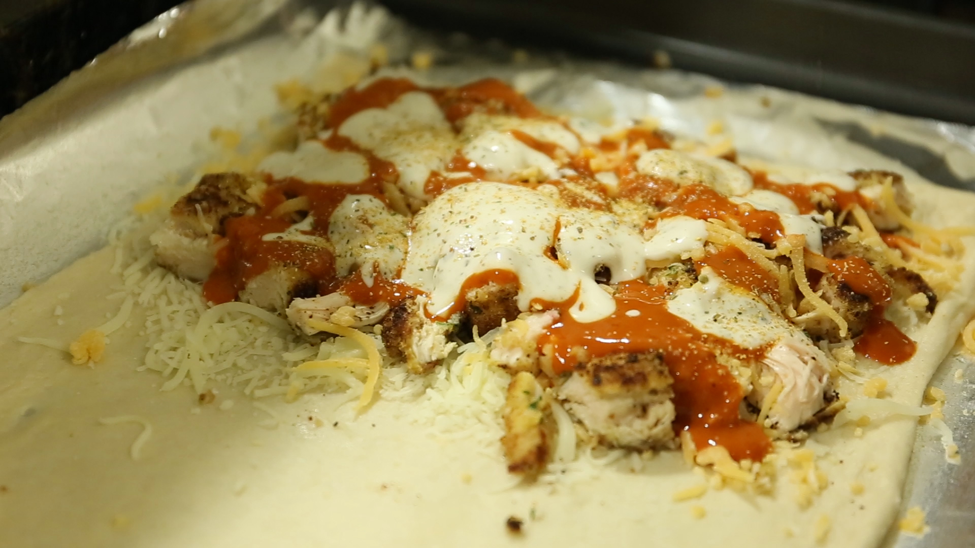 Margaux Ancel's buffalo chicken calzone just before it's folded in half and placed in the oven for 15-20 minutes, until golden brown. (Jackson Haigis/Daily Campus)