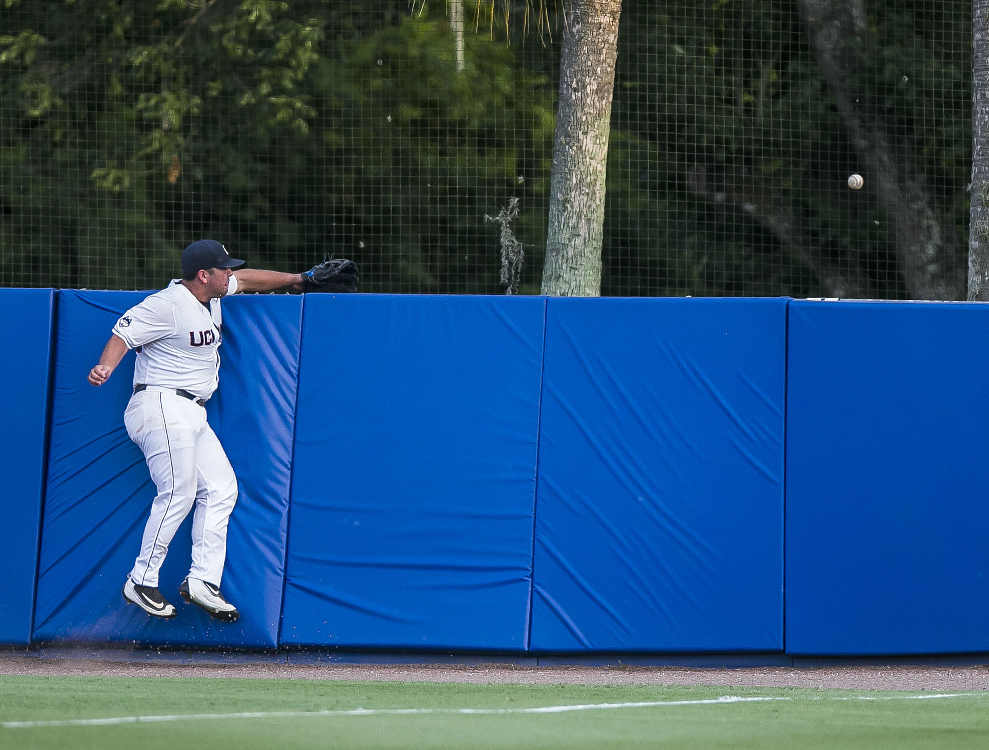 Connecticut's Joe DeRoche-Duffin cannot snag Florida's Danny Reyes's home run during an NCAA college regional baseball game Saturday, June 4, 2016, in Gainesville, Fla. (Cyndi Chambers/The Gainesville Sun via AP)