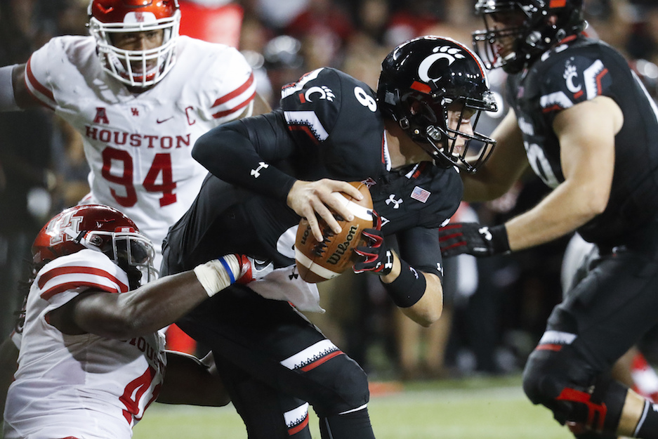 Houston linebacker Steven Taylor, left, sacks Cincinnati quarterback Hayden Moore during the second half of an NCAA college football game, Thursday, Sept. 15, 2016, in Cincinnati. Houston won 40-16. (John Minchillo/AP Photo)