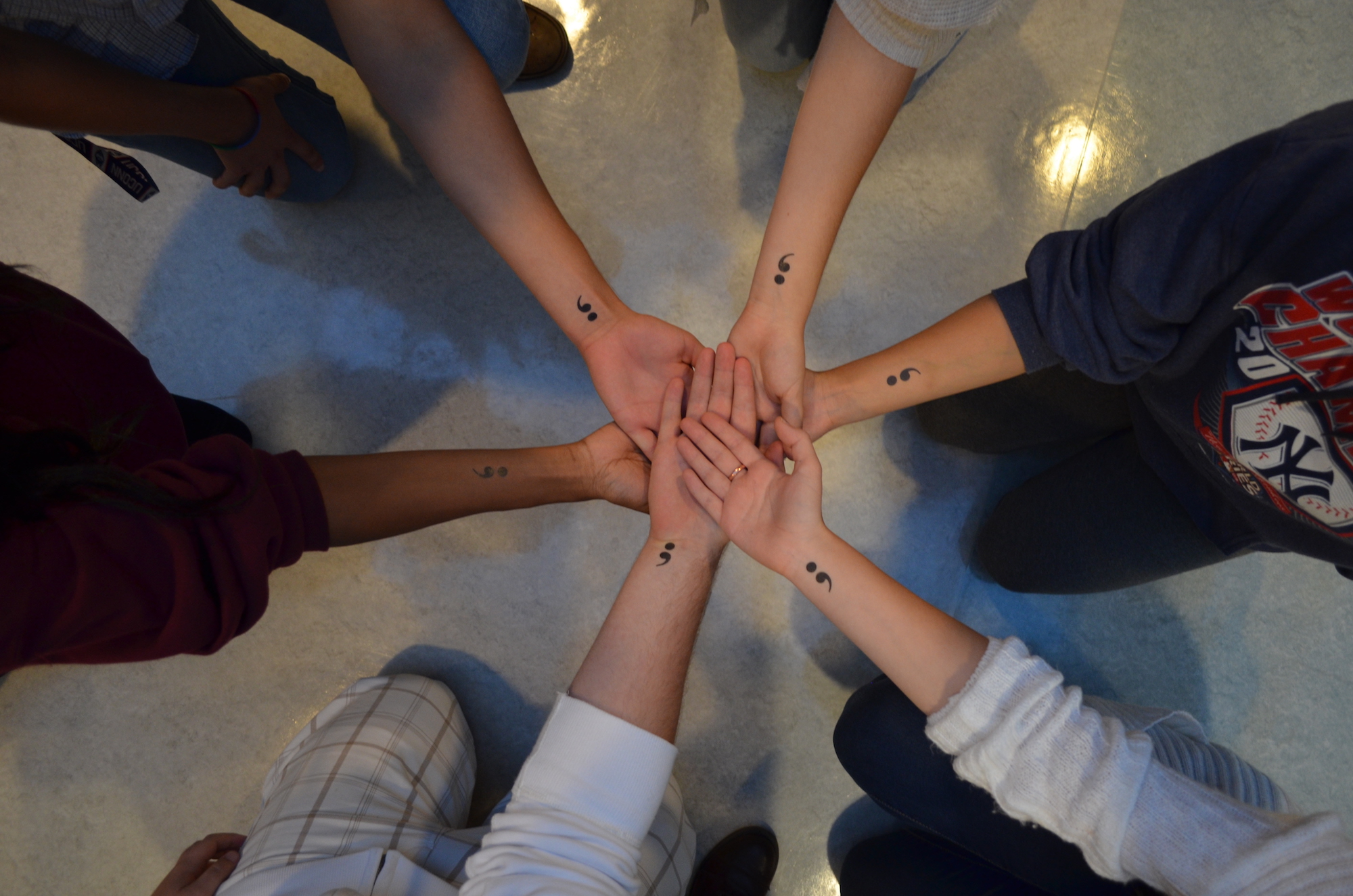 Project Semicolon was held at the Women's Center multipurpose room on the fourth floor of the Student Union as part of National Suicide Prevention Awareness Month. (Clockwise from bottom right) freshmen Julie Cahill, Ryan Chester, Ava Williams, Juwan Rose, Isabella DeSouza and Mary Khotsombath show off their Project Semicolon temporary tattoos. (Akshara Thejaswi/The Daily Campus)