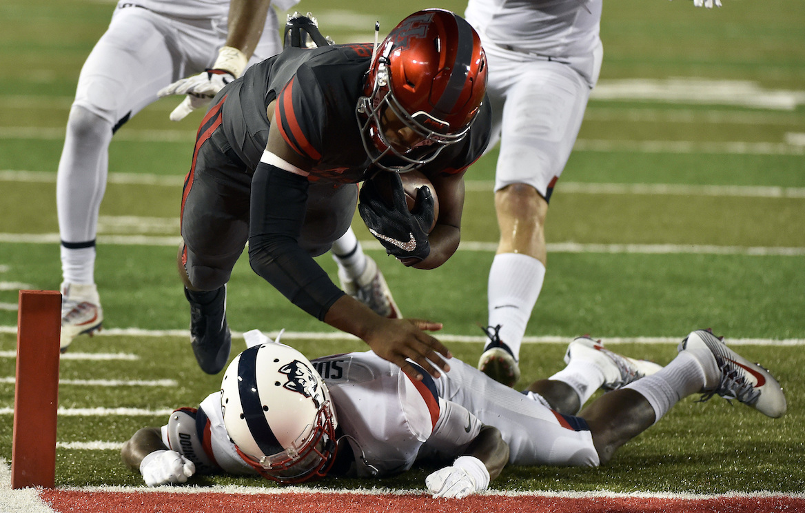 Houston quarterback Greg Ward Jr., top, leaps over Connecticut cornerback Jamar Summers to score a 10-yard touchdown in the second half of an NCAA college football game, Thursday, Sept. 29, 2016, in Houston. (Eric Christian Smith/AP Photo)