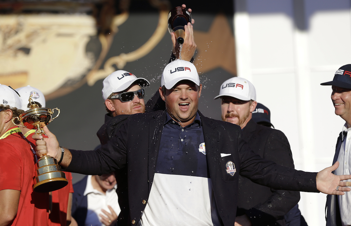 United States’ Jimmy Walker and United States’ Ryan Moore pour champagne on United States’ Patrick Reed during the closing ceremony of the Ryder Cup golf tournament Sunday, Oct. 2, 2016, at Hazeltine National Golf Club in Chaska, Minn. (David J. Phillip/AP Photo)