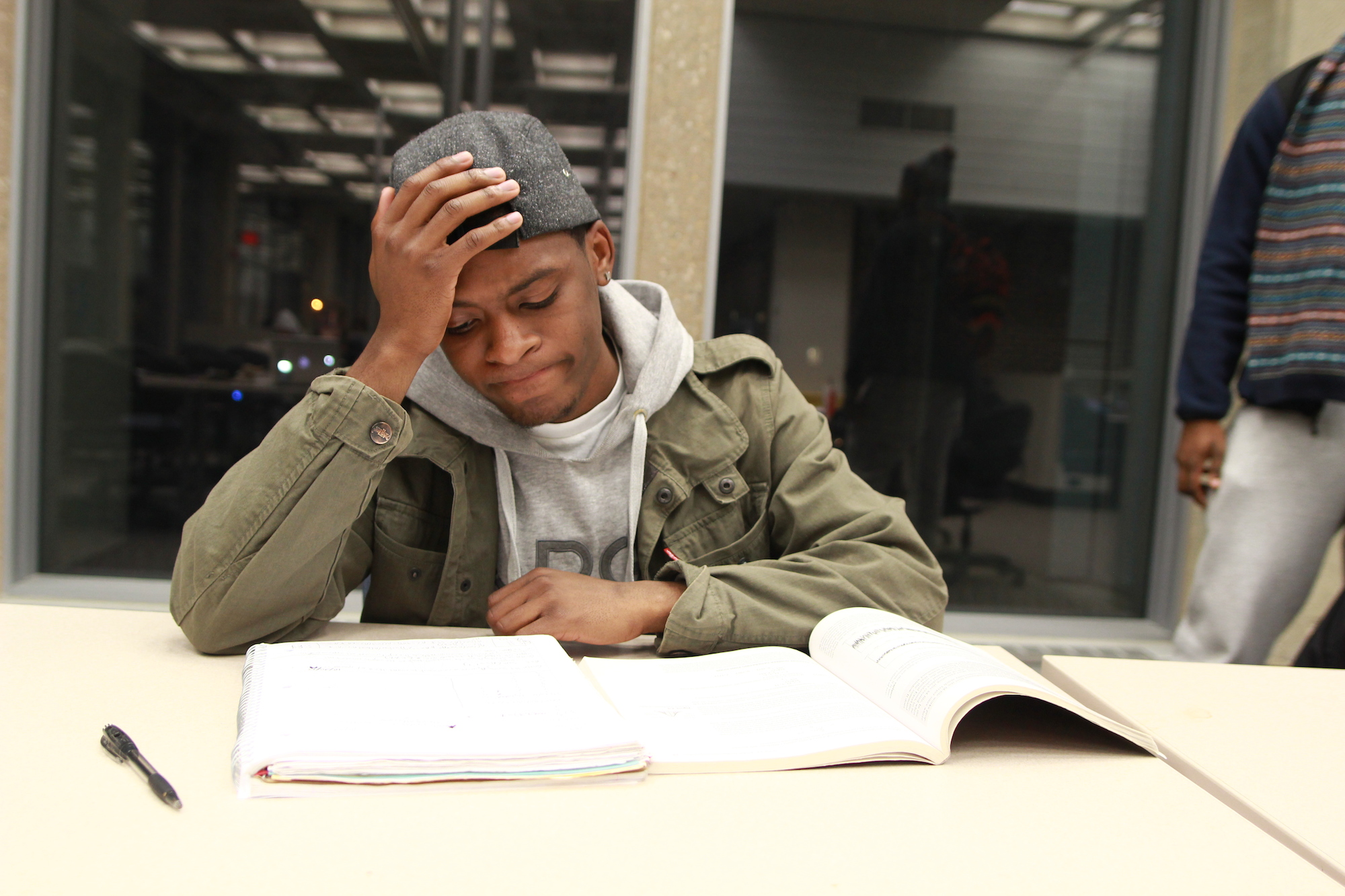 A stressed student studies at the Homer Babbidge Library on Dec. 5, 2013. (Mic Johnson/The Daily Campus)