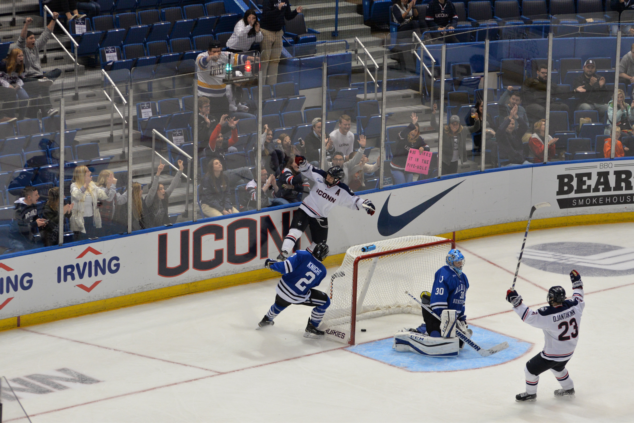 Kasperi Ojantakanen (#23) celebrates in front of the net after Spencer Naas (#8) scores a goal on UAH goaltender Matt Larose (#30) at the XL Center in Hartford, Conn. on Saturday Oct. 8, 2016. (Amar Batra/The Daily Campus)