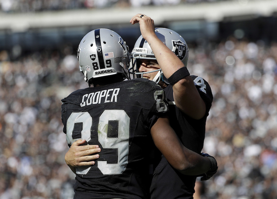 Oakland Raiders wide receiver Amari Cooper (89) and quarterback Derek Carr celebrate after connecting on a touchdown pass against the San Diego Chargers during the second half of an NFL football game in Oakland, Calif., Sunday, Oct. 9, 2016. (Marcio Jose Sanchez/AP)