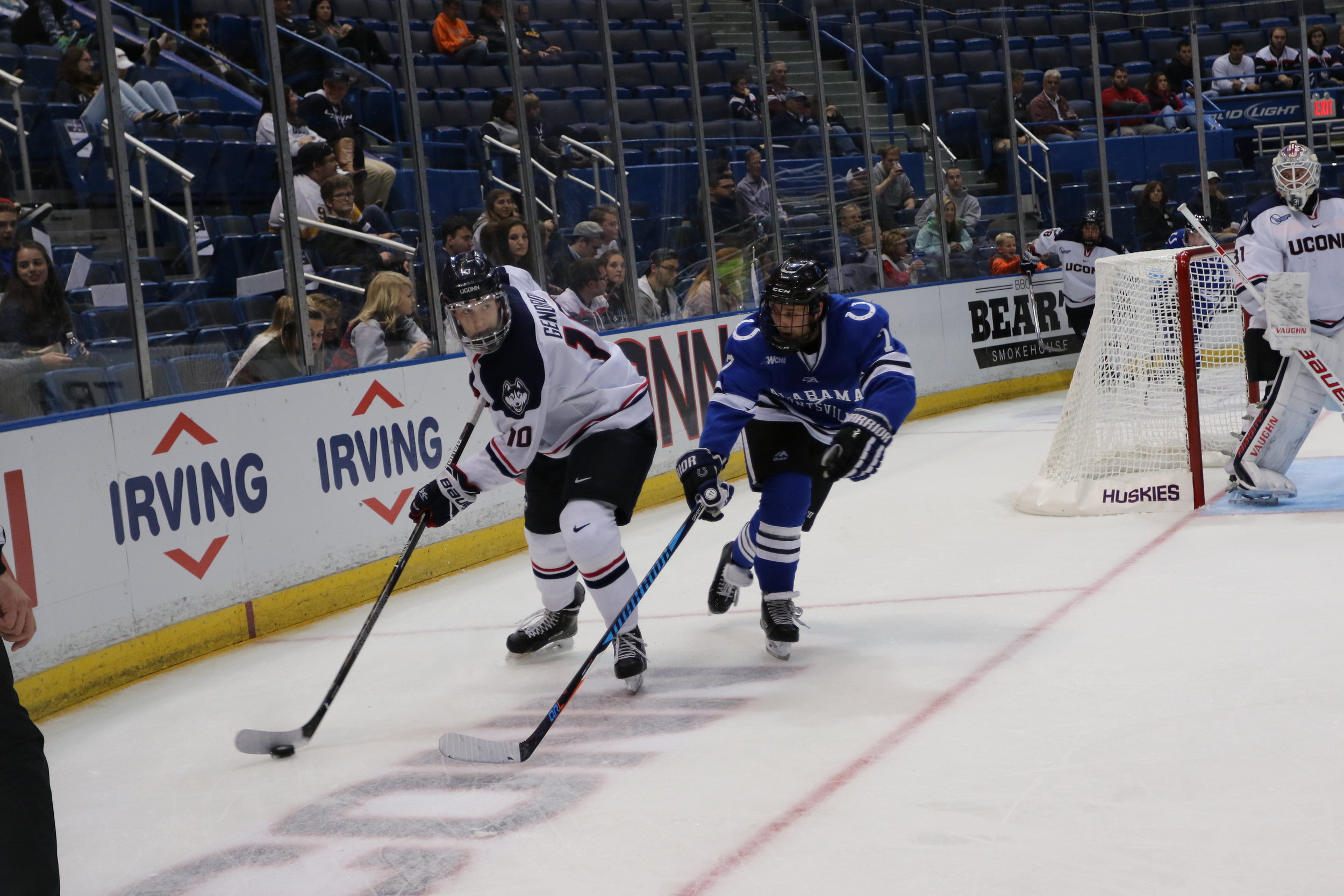 Sophomore defenseman Miles Gendron (#10) evades an Alabama-Huntsville defender as goaltender Rob Nichols (#31) looks on during the Huskies' second game of the weekend on Saturday Oct. 8, 2016 at the XL Center. The Huskies swept the weekend series outscoring the Chargers 10-0. (Ruohan Li/The Daily Campus)