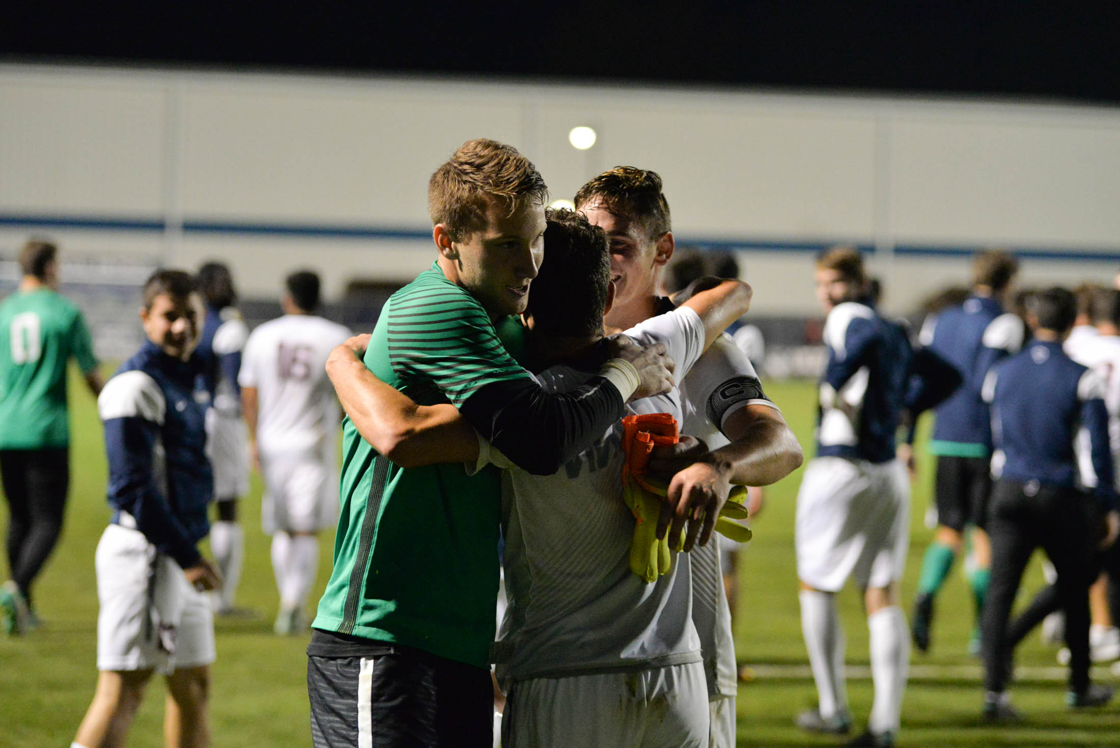 (from left to right) Goalkeeper Scott Levene, defender Dylan Greenberg and defender-captain Jake Newinski hug following the Huskies 1-0 overtime victory over Boston College on Tuesday, Oct. 18, 2016 at Morrone Stadium. Greenberg scored the game winning goal for the Huskies. (Amar Batra/The Daily campus)
