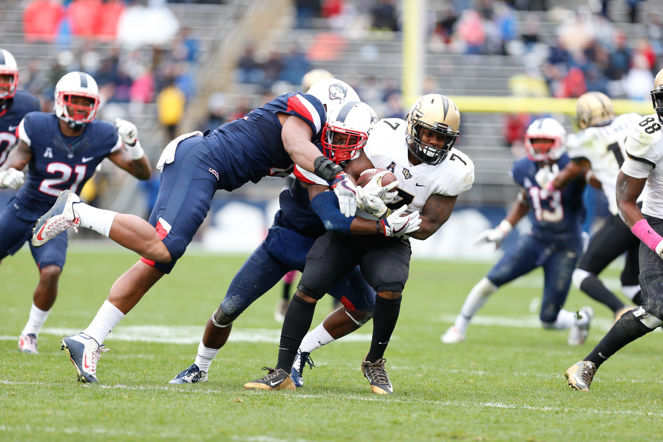 Members of the UConn defensive line tackle UCF running back Dontravious Wilson (7) during the Huskies 24-16 loss to the Knights on Saturday, Oct. 22, 2016 at Rentschler Field. The loss signaled the end of the Civil Conflict. (Tyler Benton/The Daily Campus)