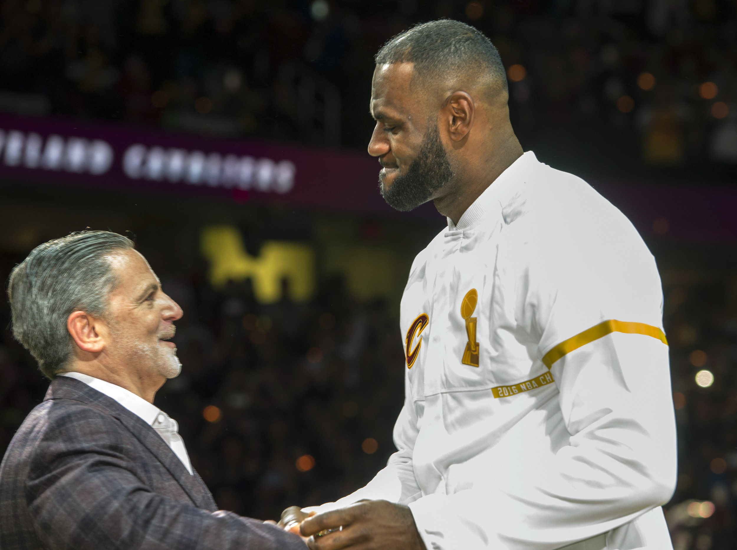 Cleveland Cavaliers' LeBron James accepts his NBA championship ring from Cavaliers owner Dan Gilbert before a basketball game against the New York Knicks in Cleveland, Tuesday, Oct. 25, 2016. (Phil Long/AP Photo)