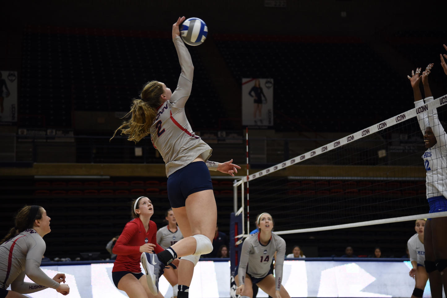 Outside hitter Danielle Cabel spikes the ball in an October 30th game against Memphis. The Huskies won 3-0. (Charlotte Lao/The Daily Campus)