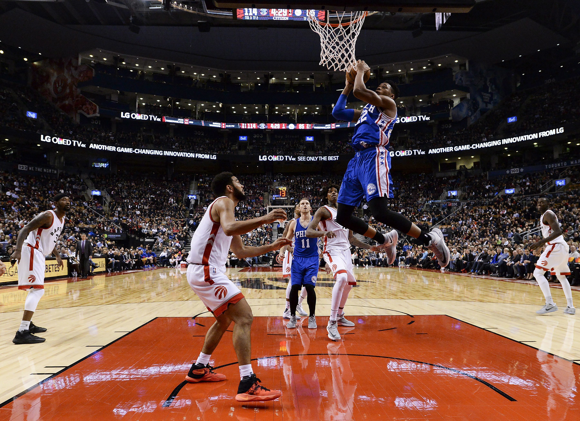 Philadelphia 76ers forward Richaun Holmes (22) goes up for a dunk shot past Toronto Raptors guard Cory Joseph (6) during the second half of an NBA basketball game in Toronto on Monday, Nov. 28, 2016. (Nathan Denette/AP)