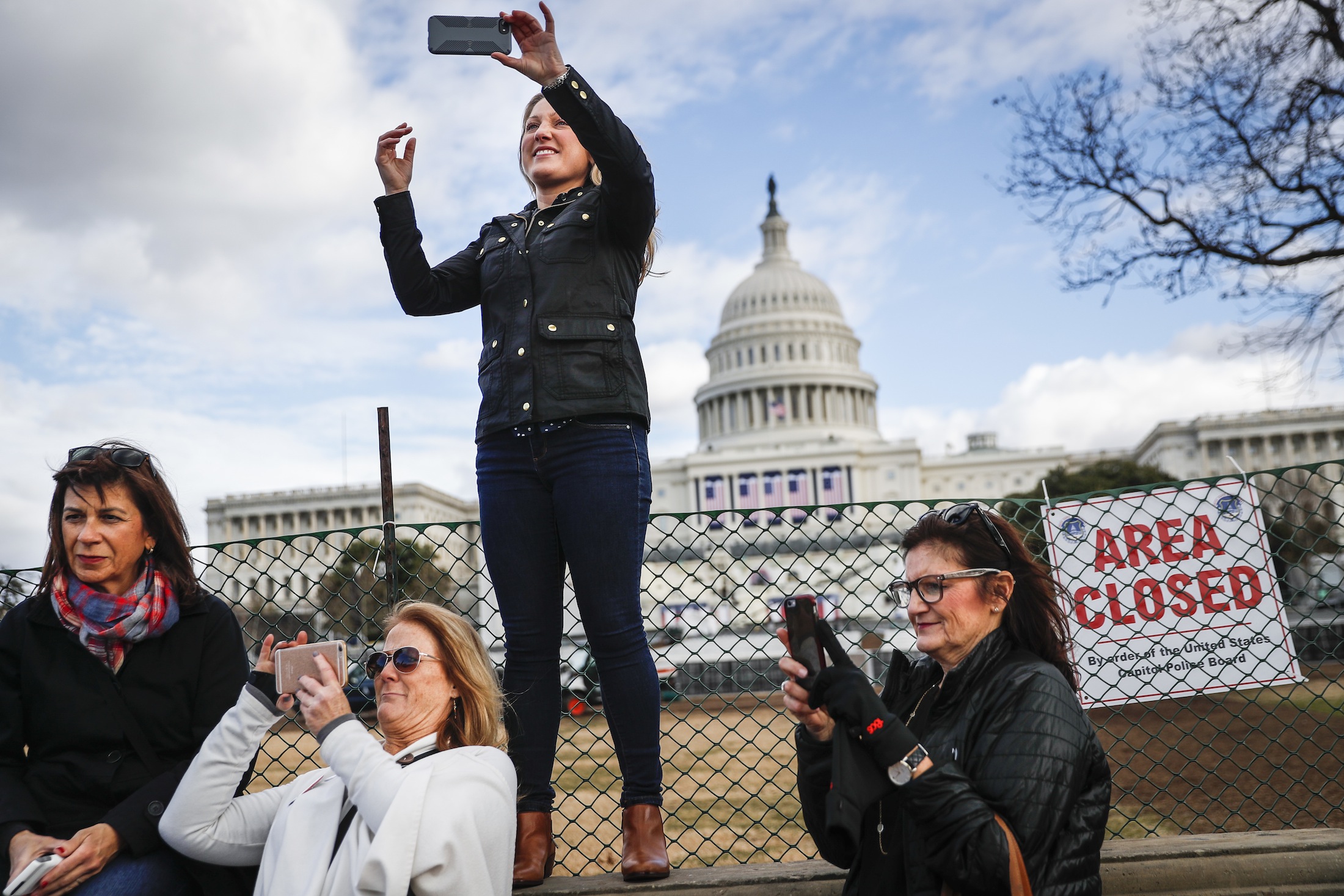 Micaela Johnson, of Leewood, Kan., in town to take part in Saturday's Women's March on Washington, takes a selfie with the Capitol Building in the background as preparations continue for Friday's presidential inauguration, Wednesday, Jan. 18, 2017, in Washington. (John Minchillo/ AP)