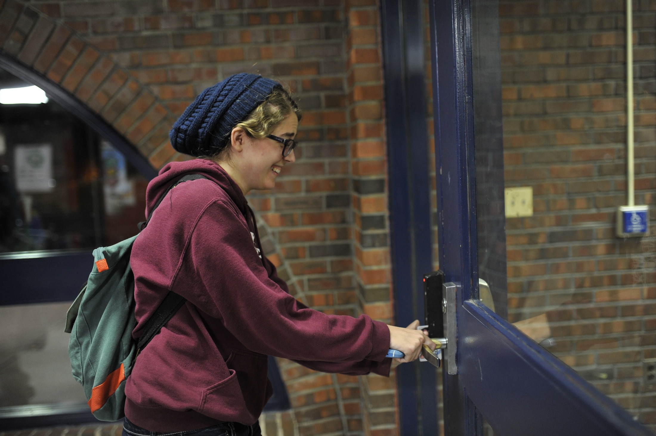 A student swipes into Buckley Residence Hall. This is the first semester that students are required to self check-in following winter break. (Jason Jiang/ The Daily Campus)